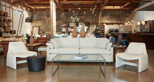 interior of Cisco Home Culver City showroom with sofa and two chairs framing the entrance