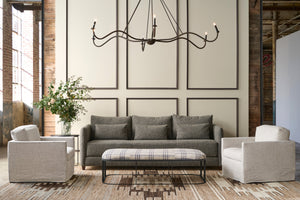  Living room with gray sofa, armchairs, and a chandelier. Photographed in Andrews Natural. 