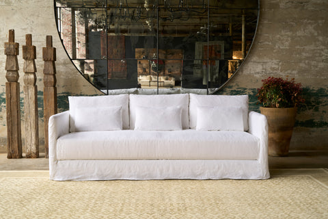 Sofa in front of a large mirror. Photographed in Otis White.