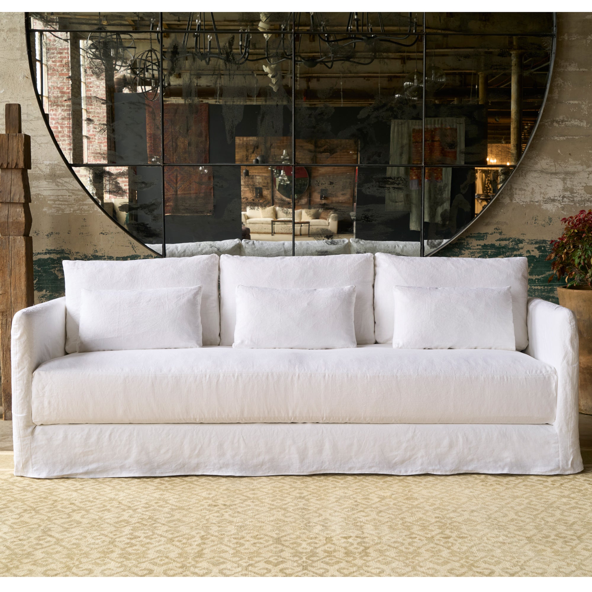  White sofa in front of an oversized mirror. Photographed in Otis White. 