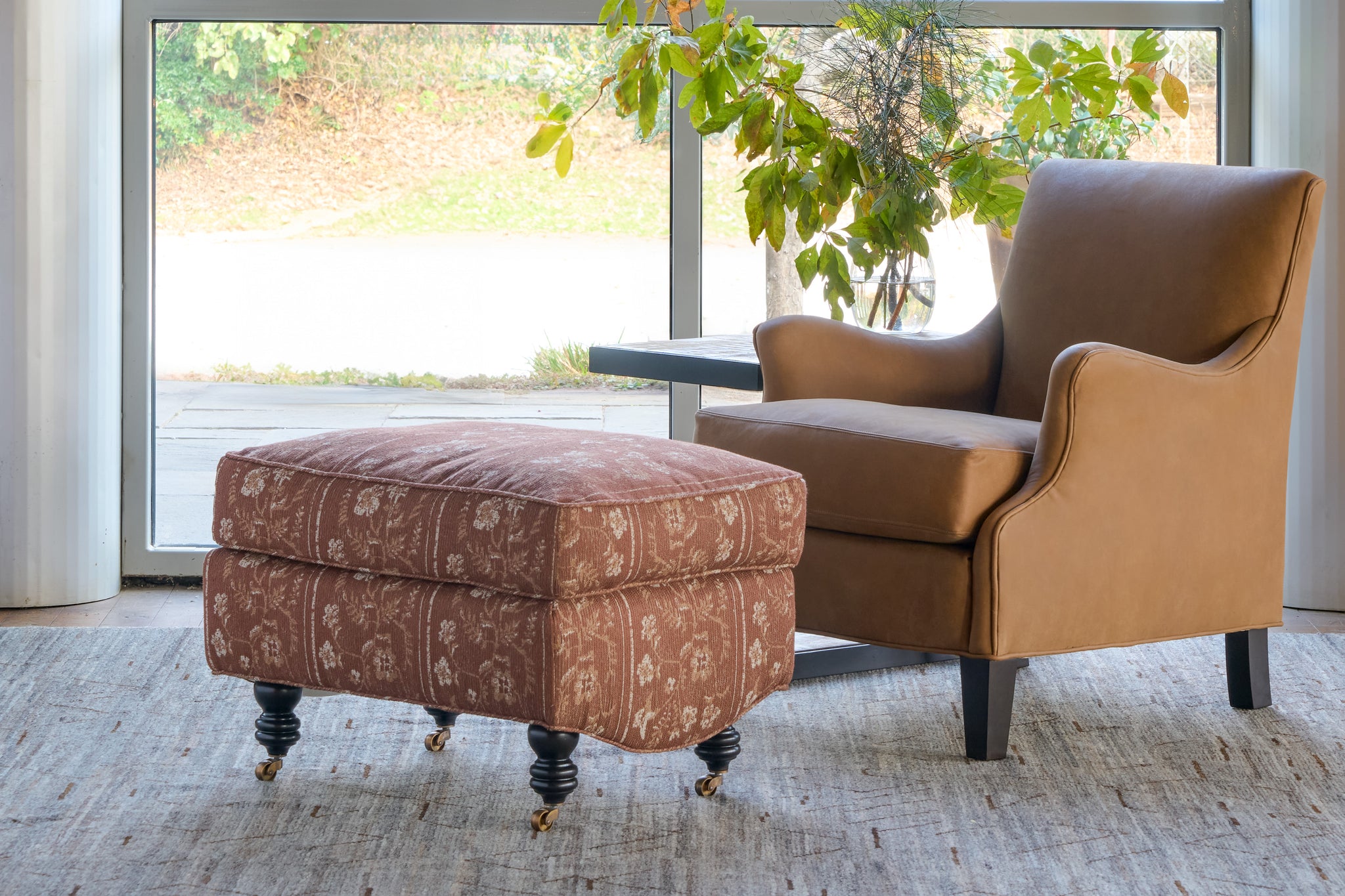  Brown leather chair with brown floral ottoman. Photographed in Marvell Latte. 
