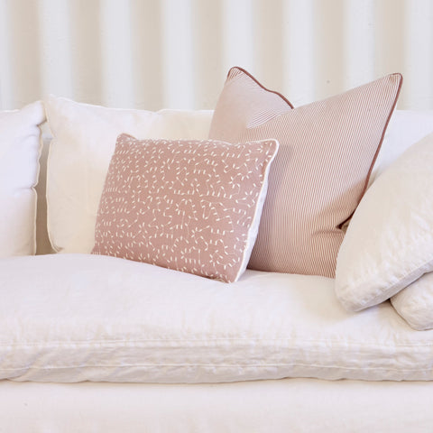 Decorative pillows on a sofa with a neutral background