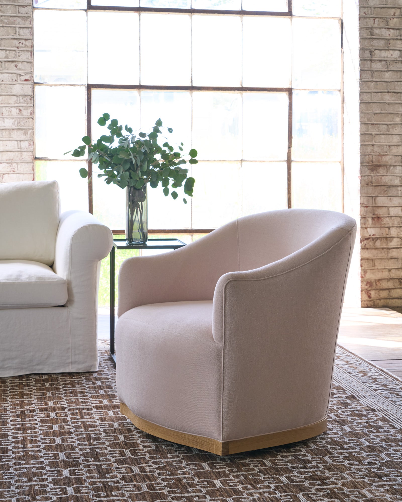  Pink Chair in a showroom on a brown rug. Photographed in Brevard Rose. 