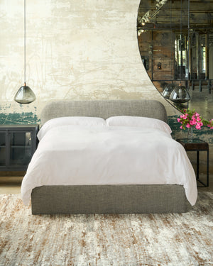  Bed in a showroom by a large mirror with smoke glass lights on the side. Photographed in Raven Peppercorn. 