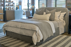  Bed in a showroom with covers and pillows. Photographed in Raven Peppercorn. 