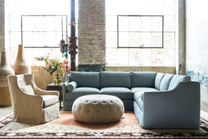  Chair and 2 arm sofa in front of 2 large windows. Large tufted pouf in the center. Photographed in Brevard Burlap. 