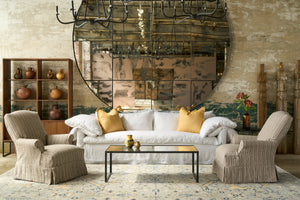  Living room with a large mirror, sofa, and armchairs. Photographed in Hickory Noire. 