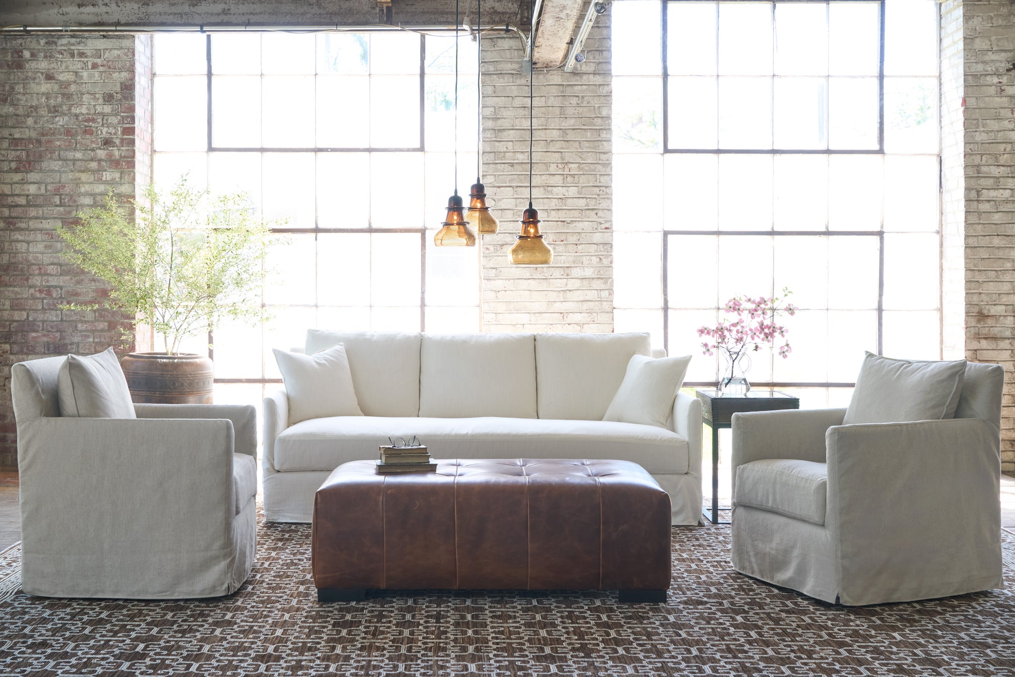  White slipcover sofa in front of a window with 2 oatmeal chairs on the side. Photographed in Elder Ivory. 