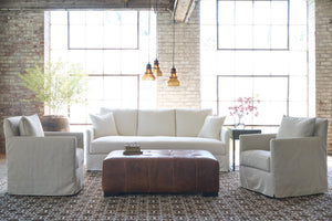  White slipcover sofa in front of a window with 2 oatmeal chairs on the side. Photographed in Elder Ivory. 