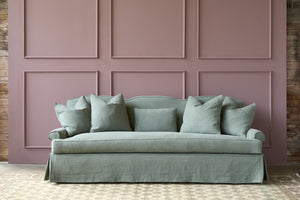  Green linen sofa in front of a purple wall. Photographed in Rye Forest. 