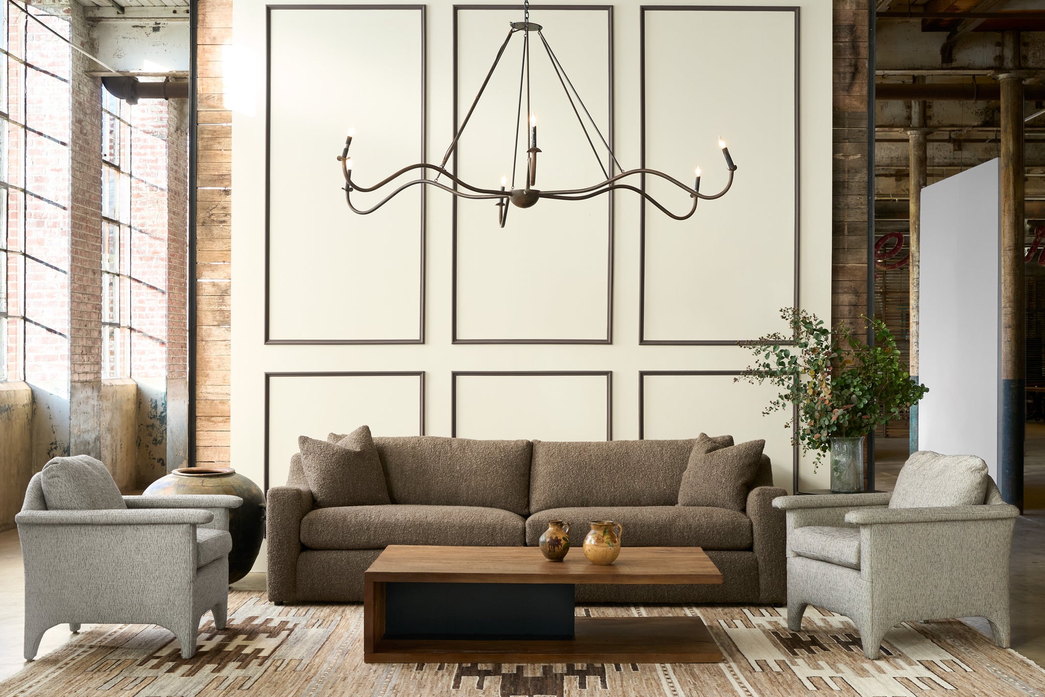  Modern living room with gray sofa, armchairs, and coffee table. Photographed in Knobby Coffee. 