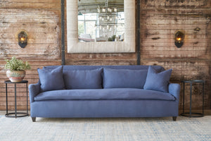  Blue sofa in front of a wood wall. Photographed in Brevard Slate. 