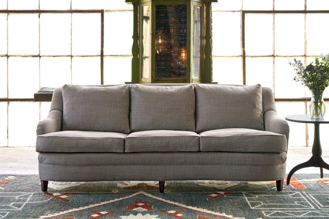 Brown Sofa in front of big windows. Photographed in Rye Acorn.