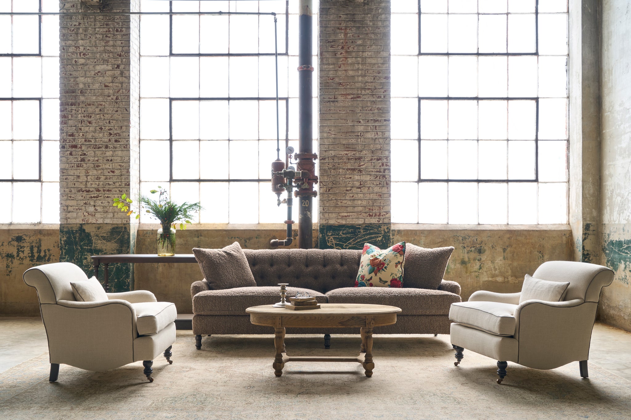  A brown sofa with 2 chairs in a showroom. Photographed in Knobby Coffee. 