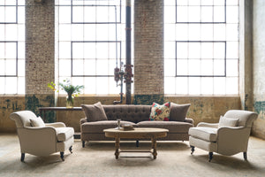  A brown sofa with 2 chairs in a showroom. Photographed in Noah Bone. 