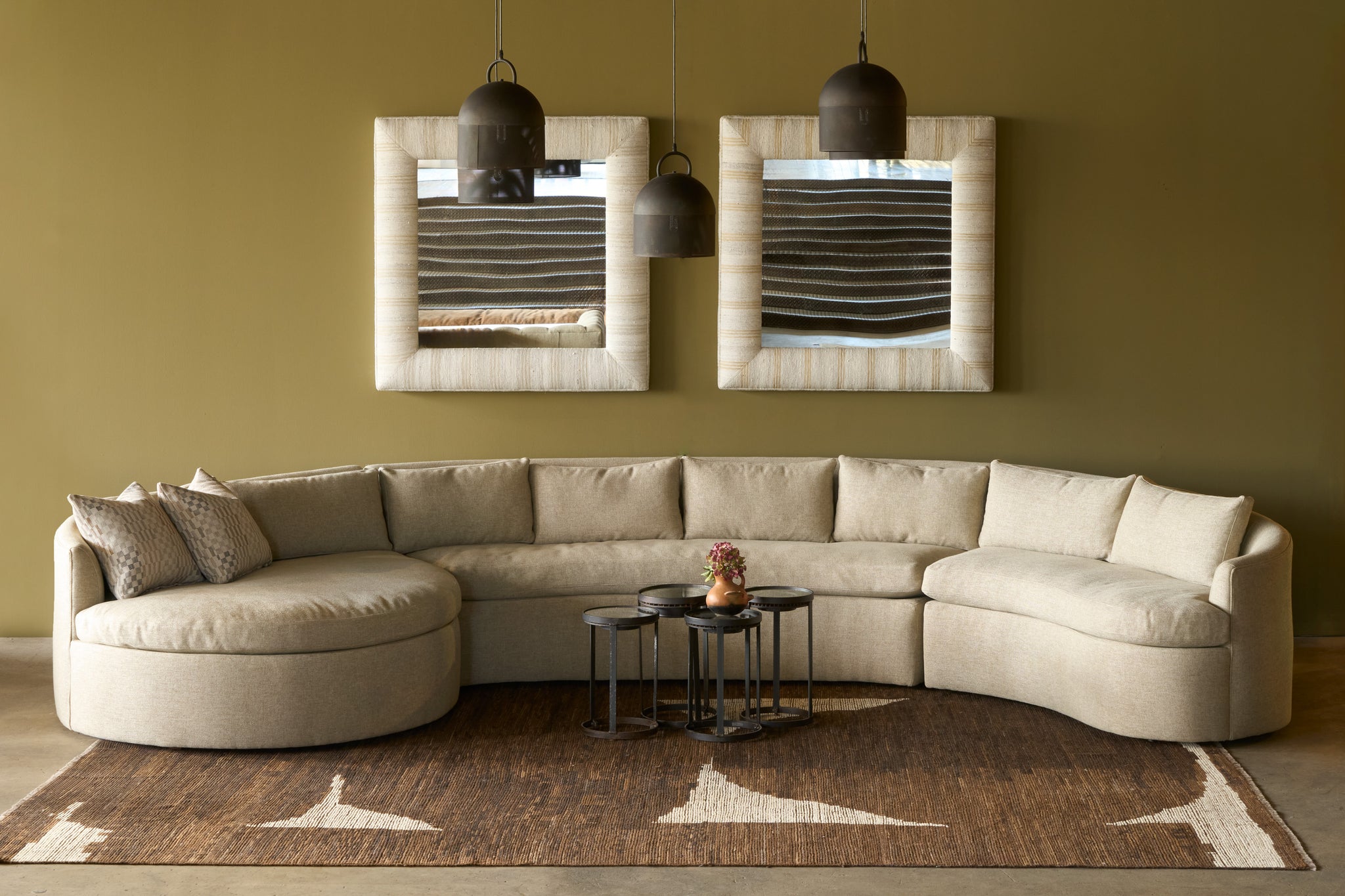  Beige sectional sofa in a room with mirrors and a rug. Photographed in Bellamy Oatmeal. 