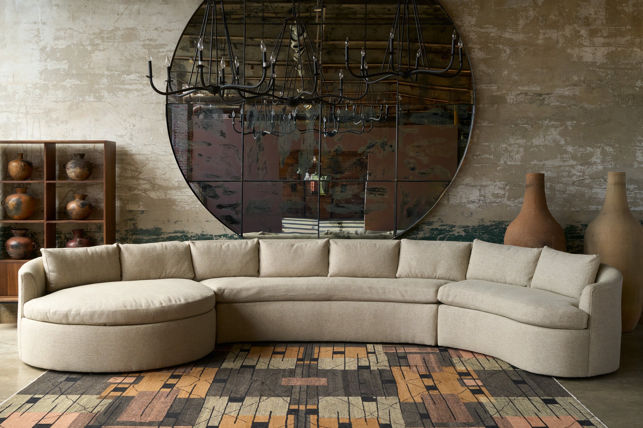  Beige sectional sofa in a room with a large mirror and decorative vases. Photographed in Bellamy Oatmeal. 