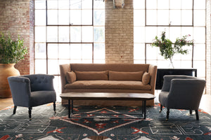  Brown sofa in front of windows with 2 chair on the side. Credenza in the back with flowers on top. Photographed in JD Rye Black. 