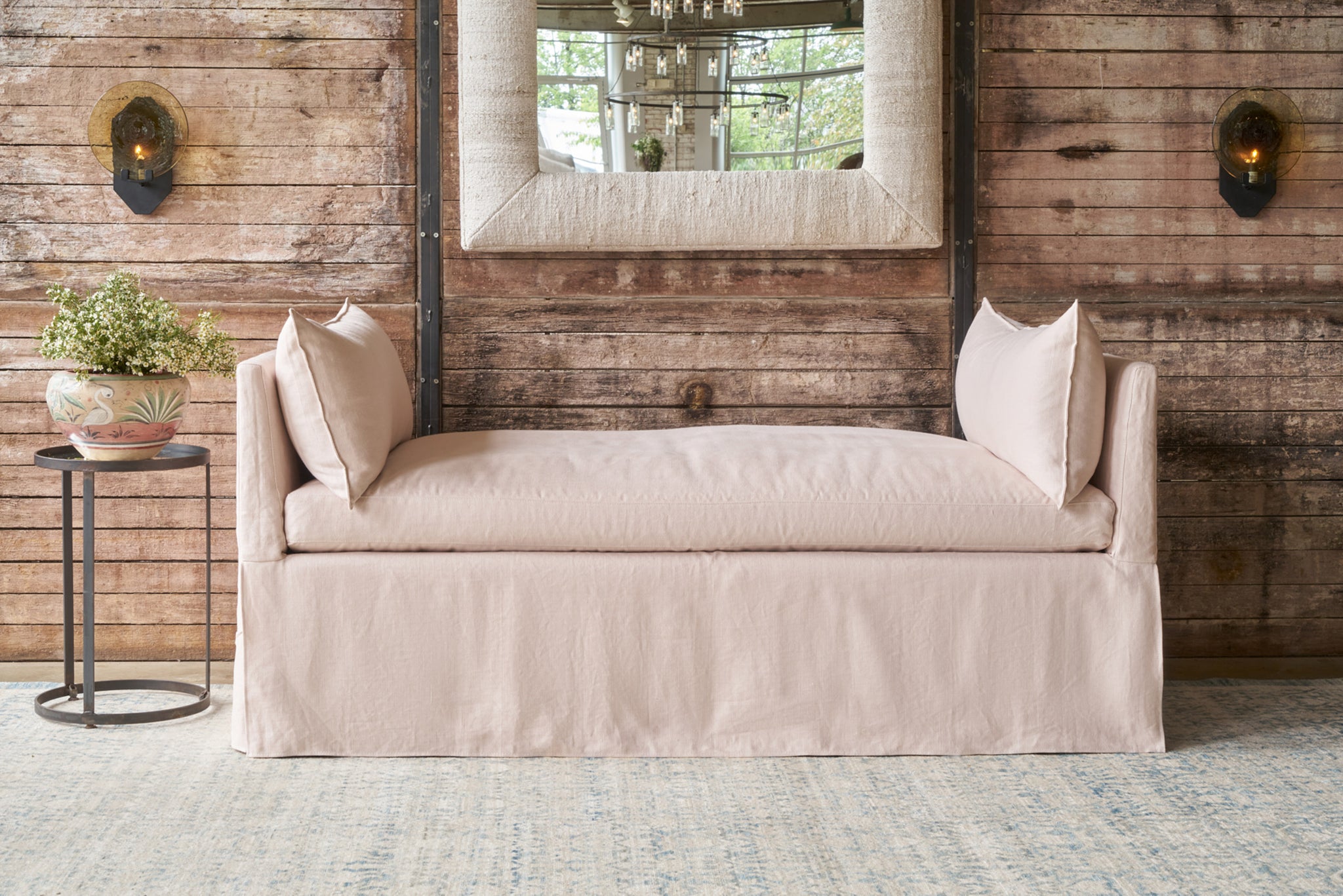  Pink linen daybed in front of a wood wall. Photographed in Brevard Rose. 