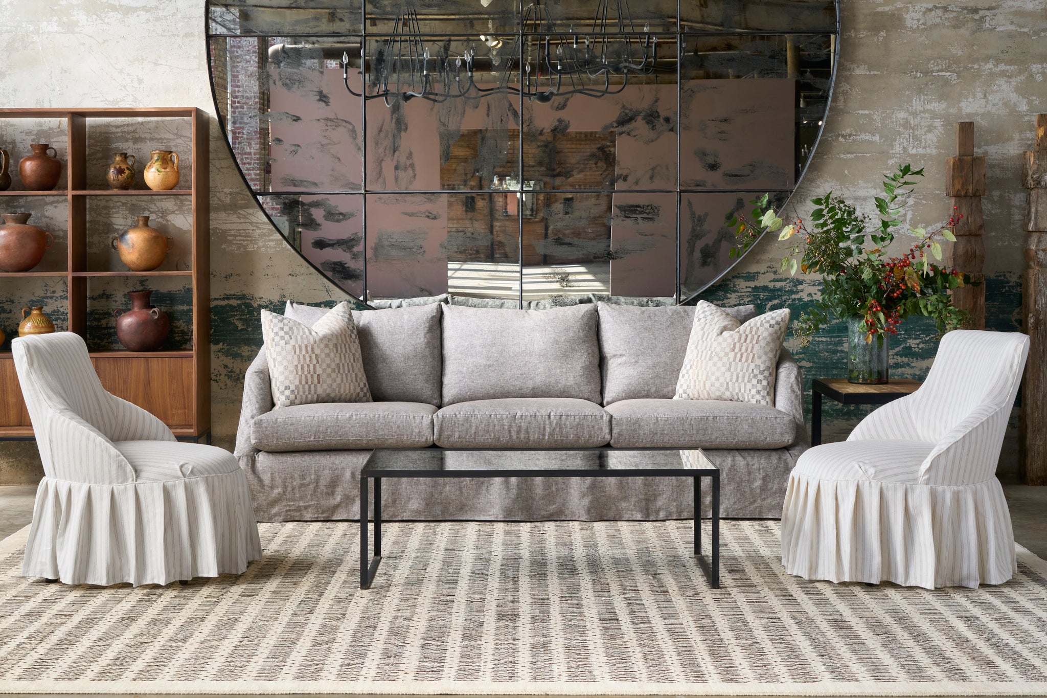  Living room with gray sofa, white chairs, and decorative items. Photographed in Beach Ivory. 