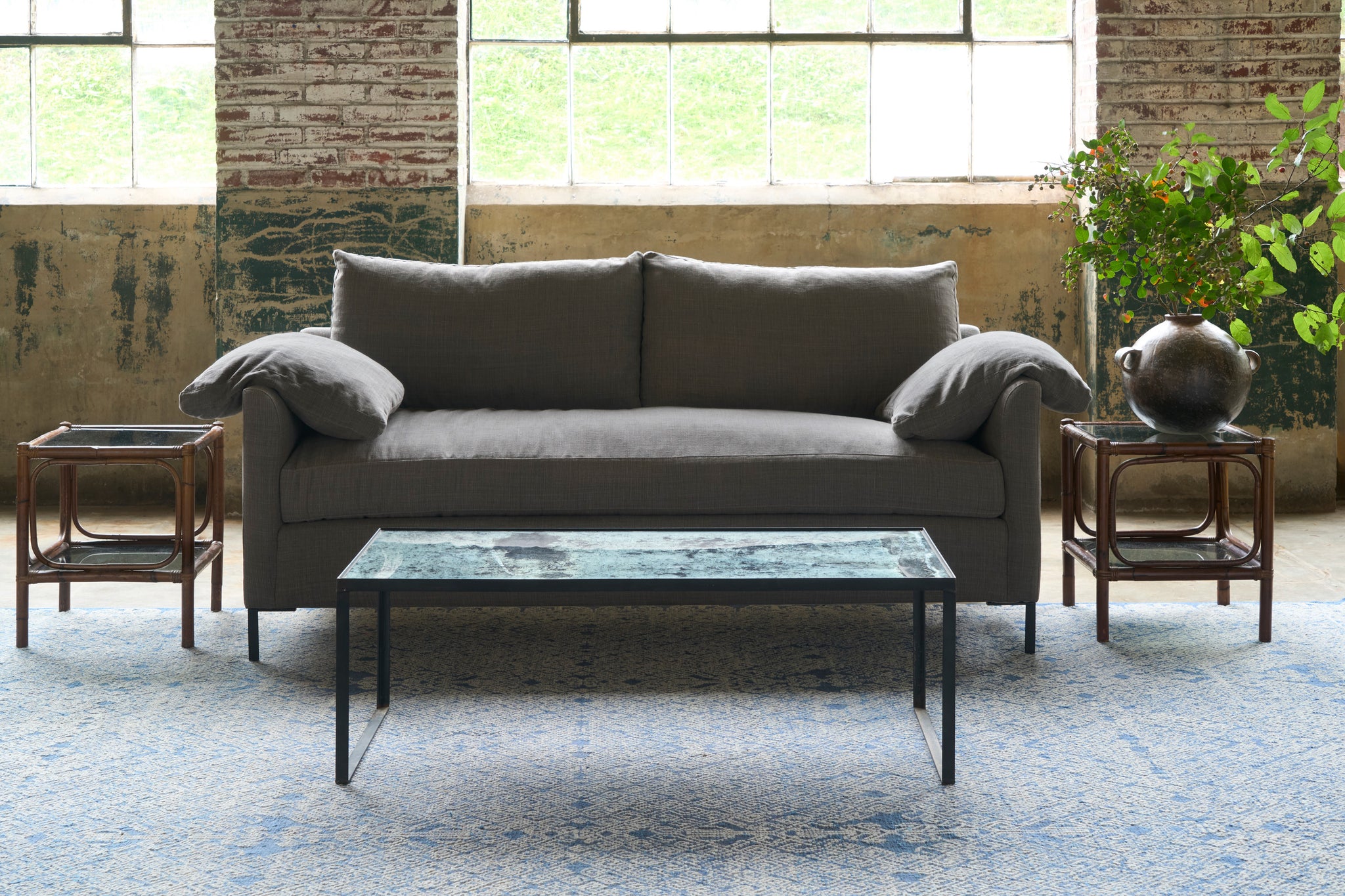  Sofa in a showroom with a coffee table in front. Photographed in Rye Warm Grey. 