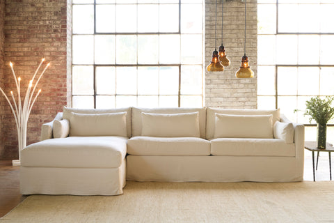 White sectional in front of 2 big windows. Photographed in Molino Ivory.