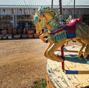  outdoor image of barn at round top with yellow horse from carousel 