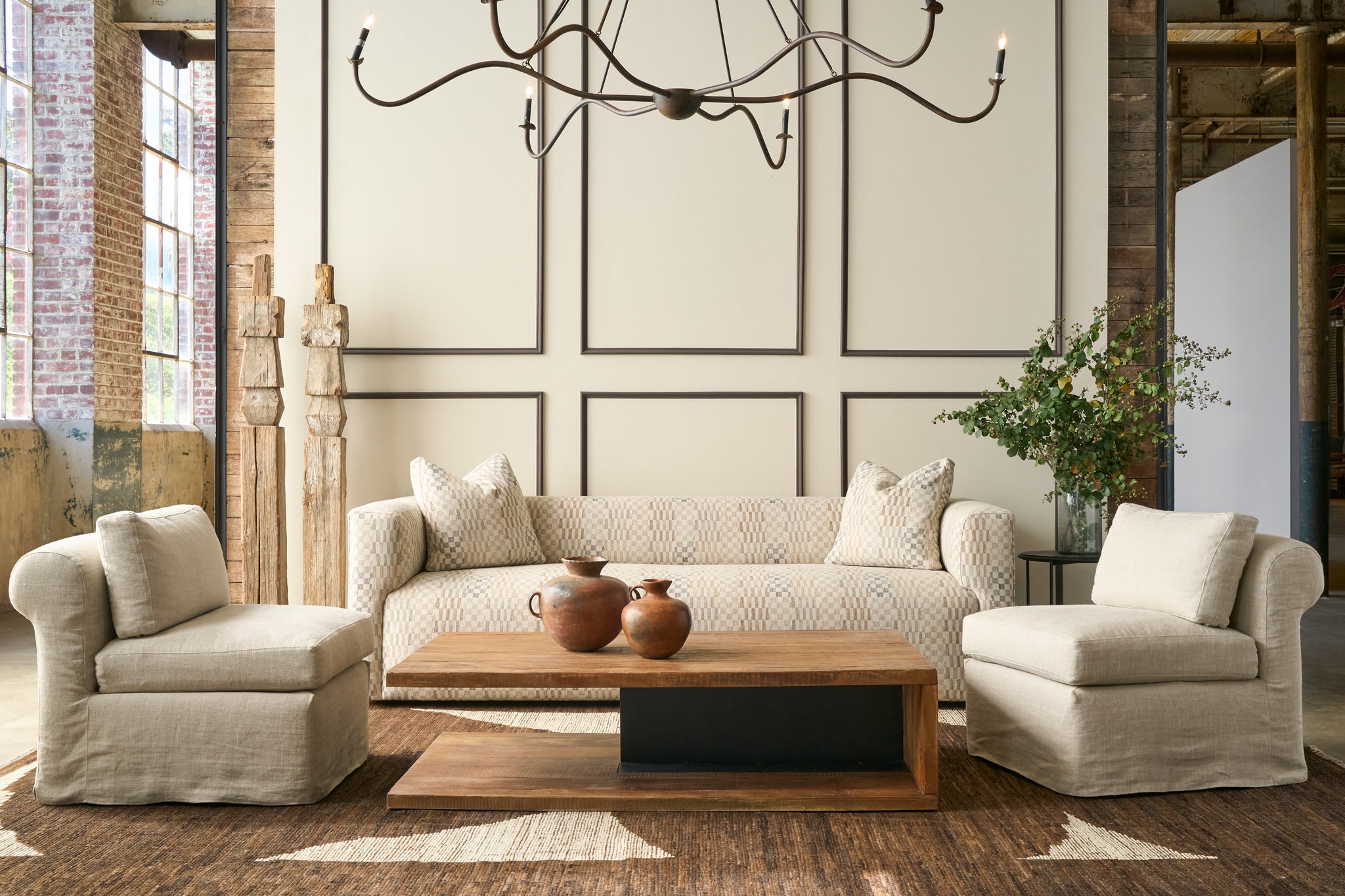  Living room with beige sofa, armchairs, and wooden coffee table. Photographed in Damas Mineral. 