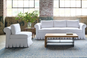  White sofa and chair with a wood coffee table. Photographed in Luna White. 