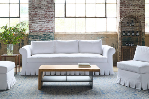 White sofa and chairs with a wood coffee table. Photographed in Luna White.