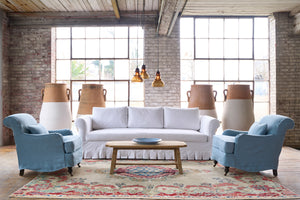  White sofa with 2 blue chairs. Wood coffee table. Photographed in Luna White. 