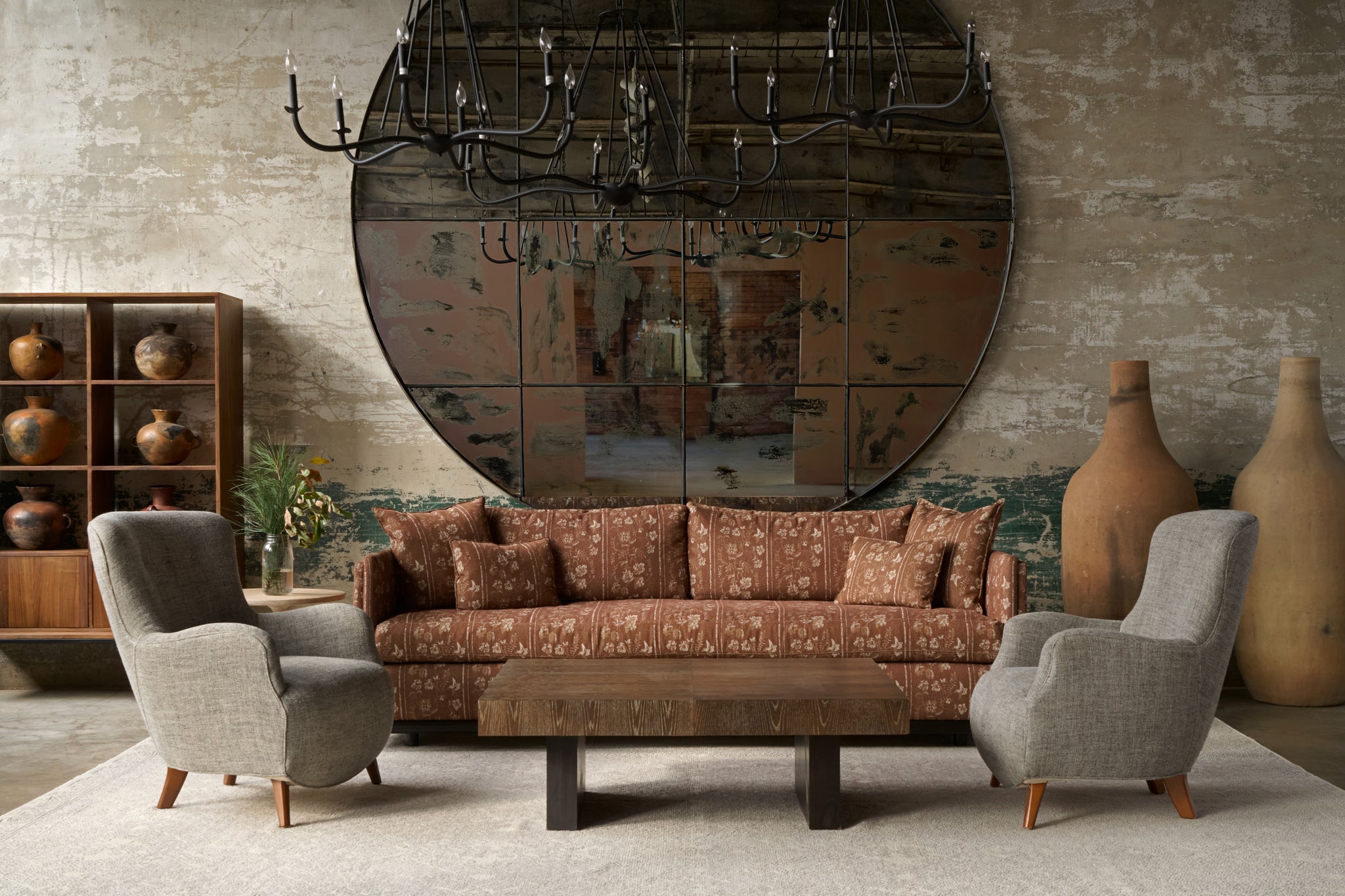  Living room with patterned sofa, armchairs, and decorative items against a textured wall. Photographed in Foret Rust. 