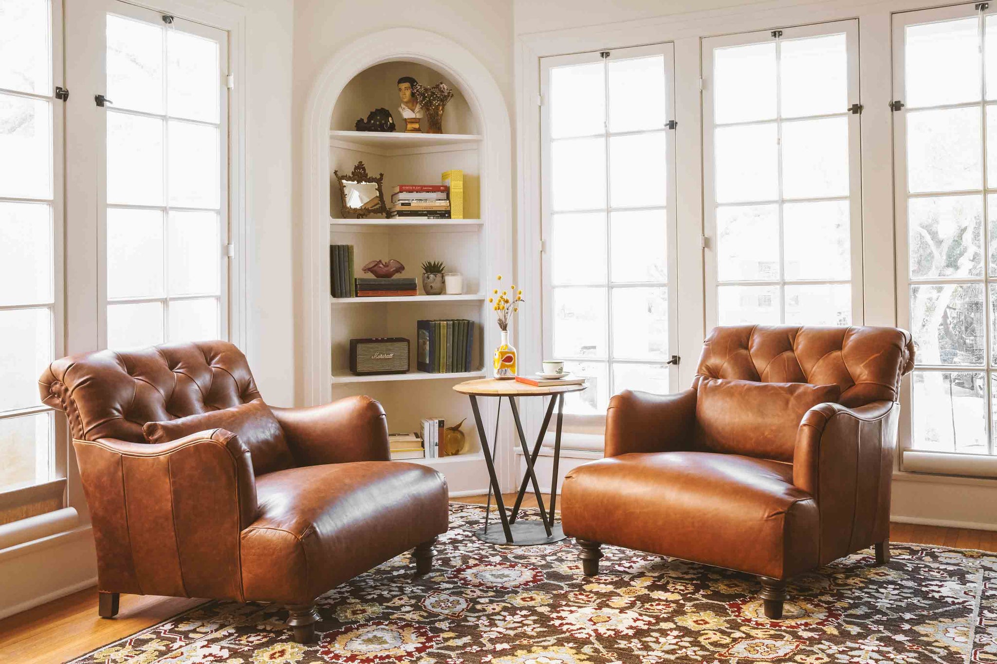  Leather chairs in Spur Terracotta in a white room sitting in front of large windows. Photographed in Spur Terracotta. 