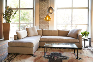  Sectional in front of large windows with 2 glass pendant and a mirrored coffee table. Photographed in Lan Oatmeal. 