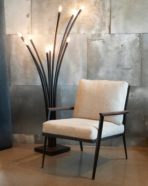  Chair in front of a metal wall with a floor lamp on the left. Photographed in Segura Natural. 