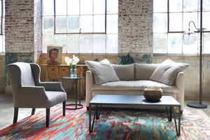  Natural color loveseat with Butterfly chair in grey linen. Floor lamp on the right. Photographed in Rye Warm Grey. 