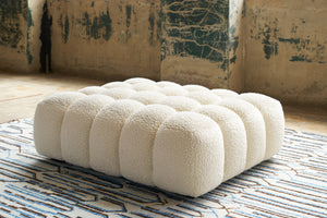  Cole Ottoman in Wooly White. Underneath is a textured rug. Photographed in Wooly White. 