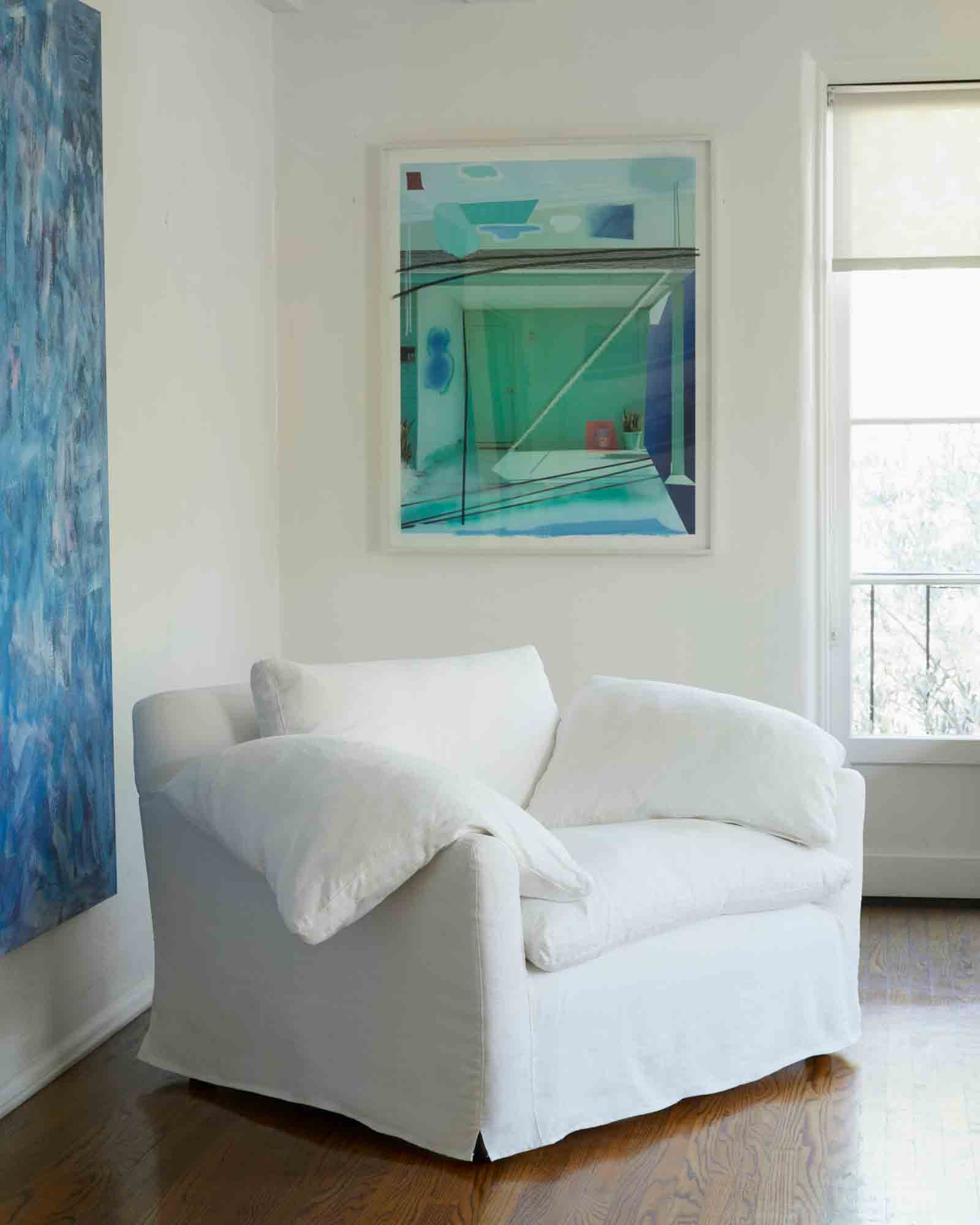  Chair in Otis White. In the background are white walls and colorful paintings. Photographed in Otis White. 