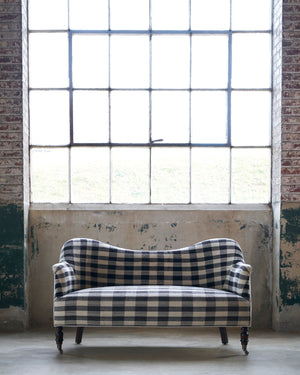  Loveseat in front of a window in a checkered fabric. Photographed in Pisco Espresso. 