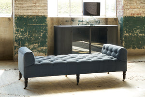  Tufted bench in blue linen with a metal console behind and a table lamp on top. Photographed in Rye Midnight Blue. 