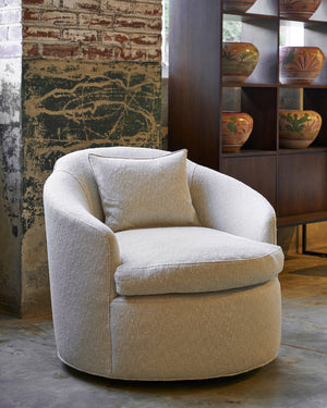  The Grace Chair is a light colored fabric in front of a cabinet with painted pots. Photographed in Segura Natural. 
