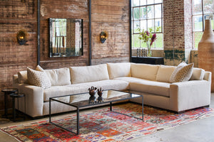  Loft 2 Arm Sectional in Segura Natural next to a glass coffee table. Photographed in Segura Natural. 