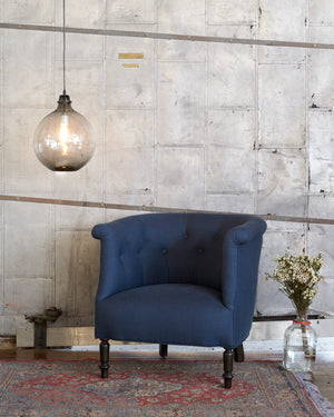  Madeline chair in Amadio Lapis (discontinued) next to a glass jug lamp. Photographed in Amadio Lapis. 
