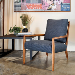  Montauk Chair in Tori Indigo next to a metal side table. Photographed in Tori Indigo. 
