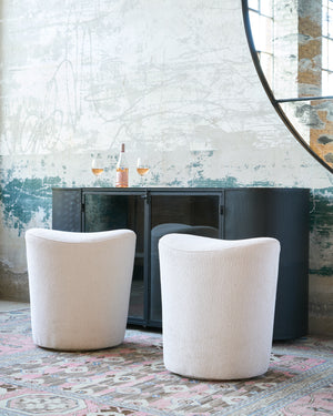  Two counter stools in white in front of a dark credenza. Photographed in Lumi Bone 
