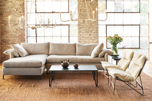  The Radley Sectional is shown with a left arm facing chaise in Arlington Stone fabric sitting with 2 metal chairs with cream colored cushions. Photographed in Vanocur Natural. 