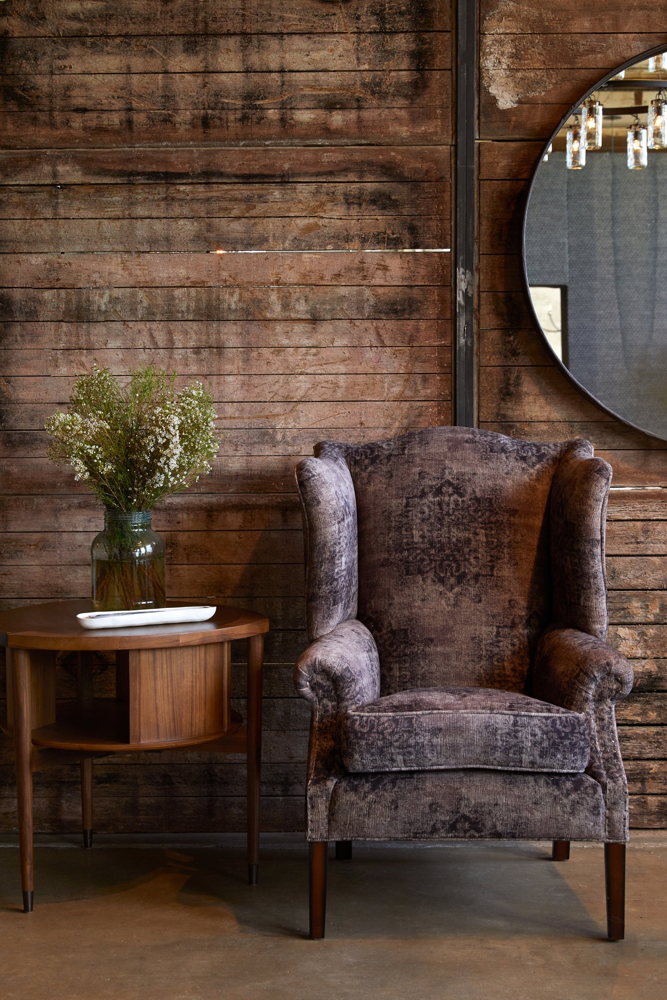 Thorn Tail chair in Tabriz Peppercorn next to a wood side table. In the background is a wood wall with a mirror hanging. Photographed in Tabriz Peppercorn. 