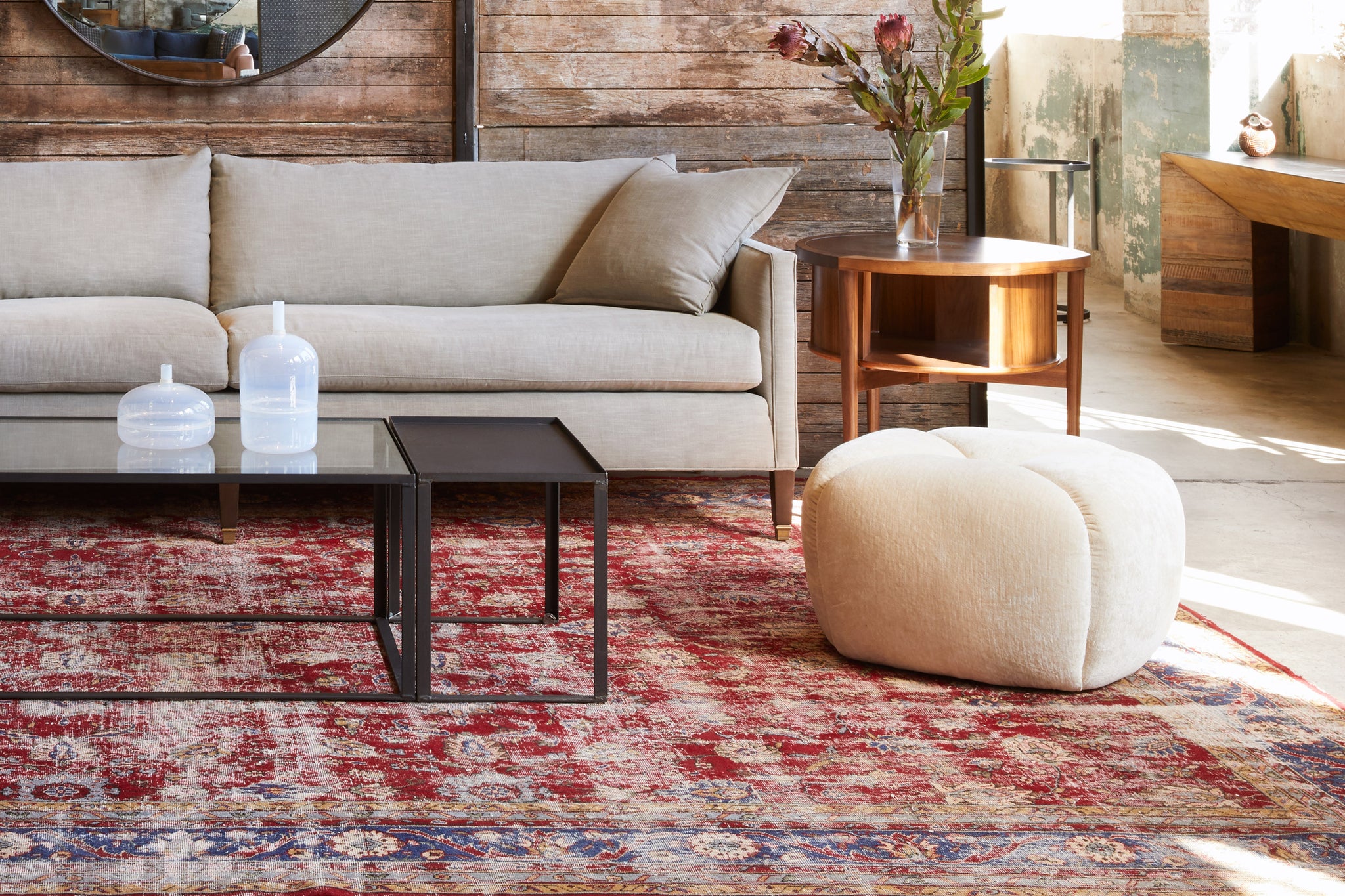  Tonto Ottoman in Velluto Natural next to a tab sofa and wood side table. Photographed in Velluto Natural. 