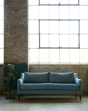  Blue sofa in front of a large window. Photographed in Brevard Marine Blue. 